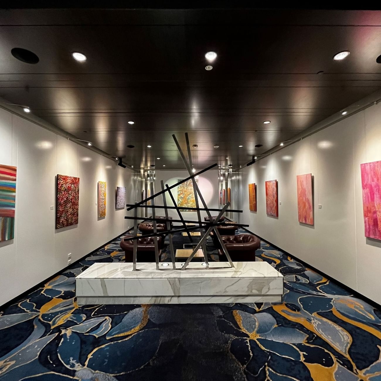 An art gallery featuring various paintings displayed elegantly on the walls near Sofitel Brisbane Central