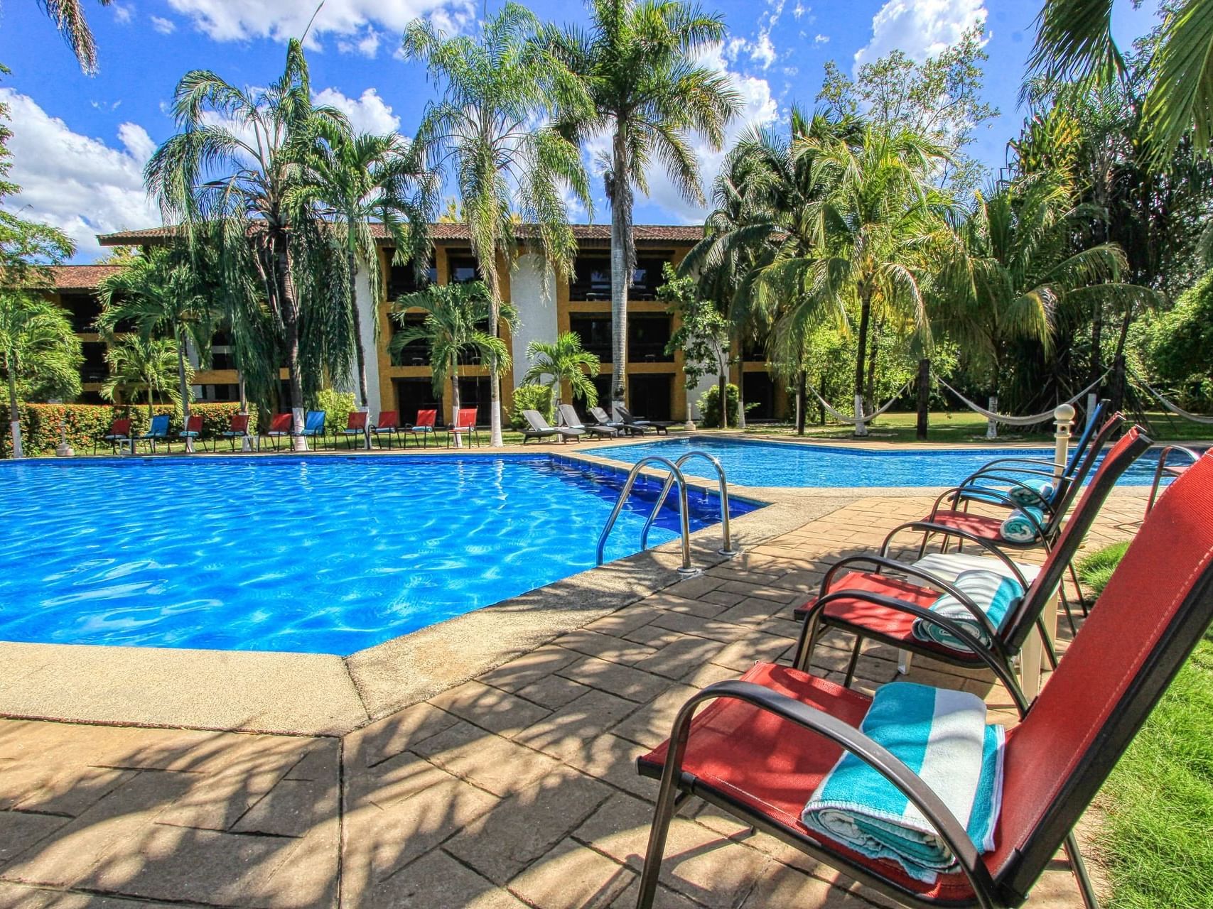 Sunbeds by the outdoor swimming pool at Ciudad Real Palenque