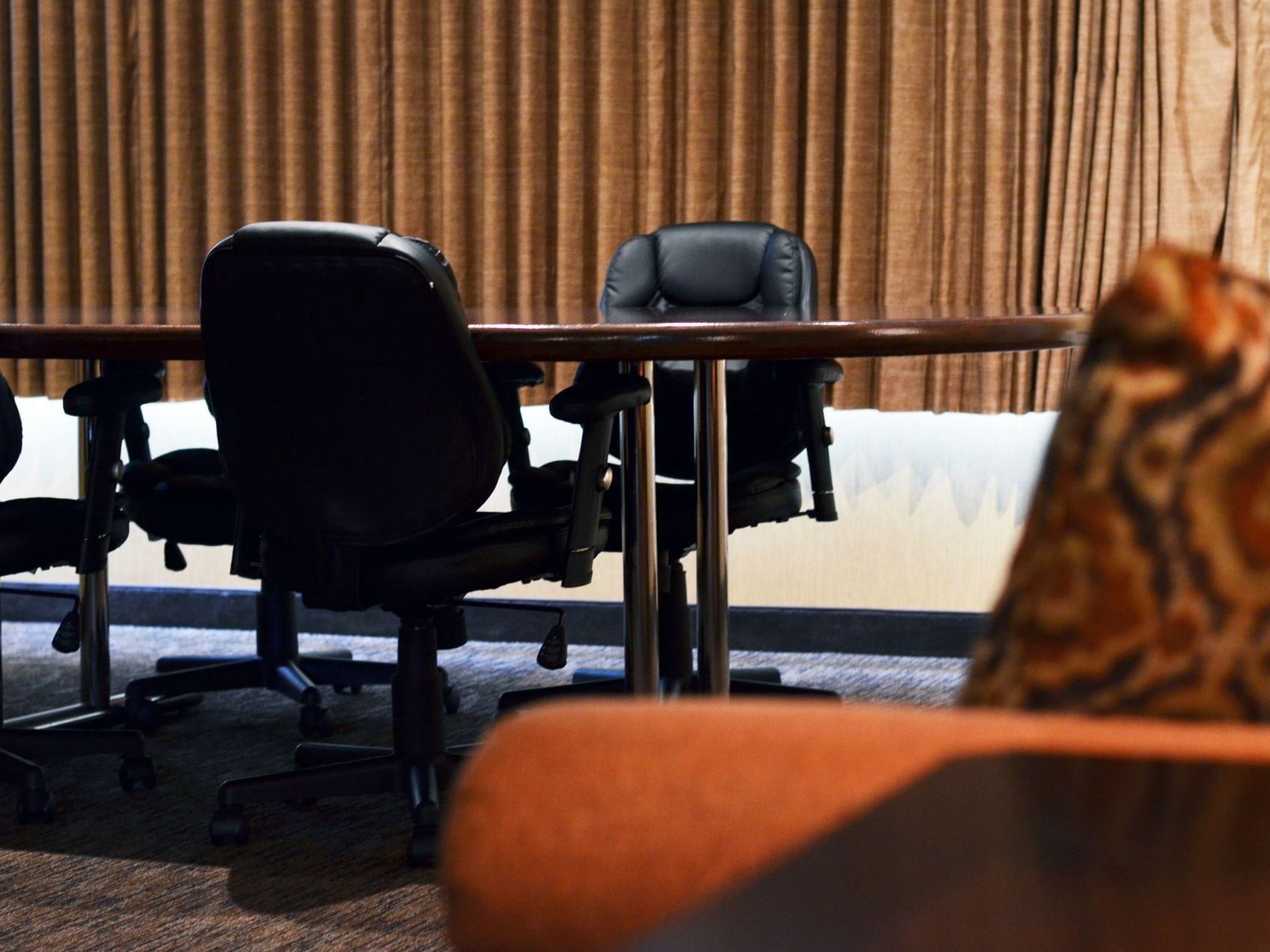 Table and chairs setup in Deluxe Suite with Conference Table at Evergreen Resort in Cadillac.