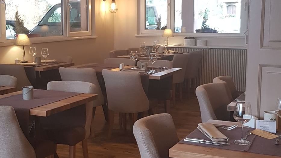 Dining tables set up in the restaurant at Le Kastelberg