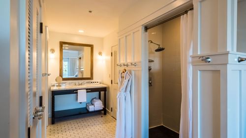 Bathroom area with hanging bathrobes in the Resort suite at Watersound Inn