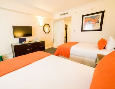 An interior of a room with two beds at Jamaica Pegasus Hotel