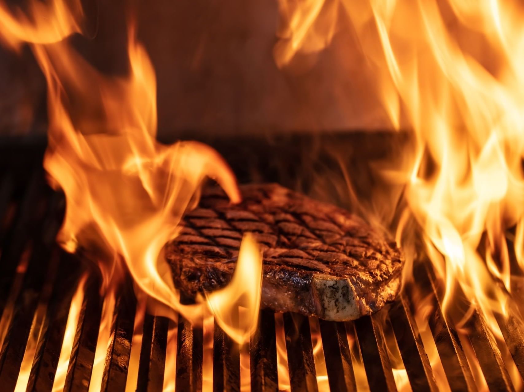Grilling steak for steak night at MCM Elegante Beaumont