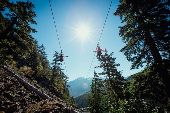 Two persons ziplining at Superfly Ziplines, Adara Hotel