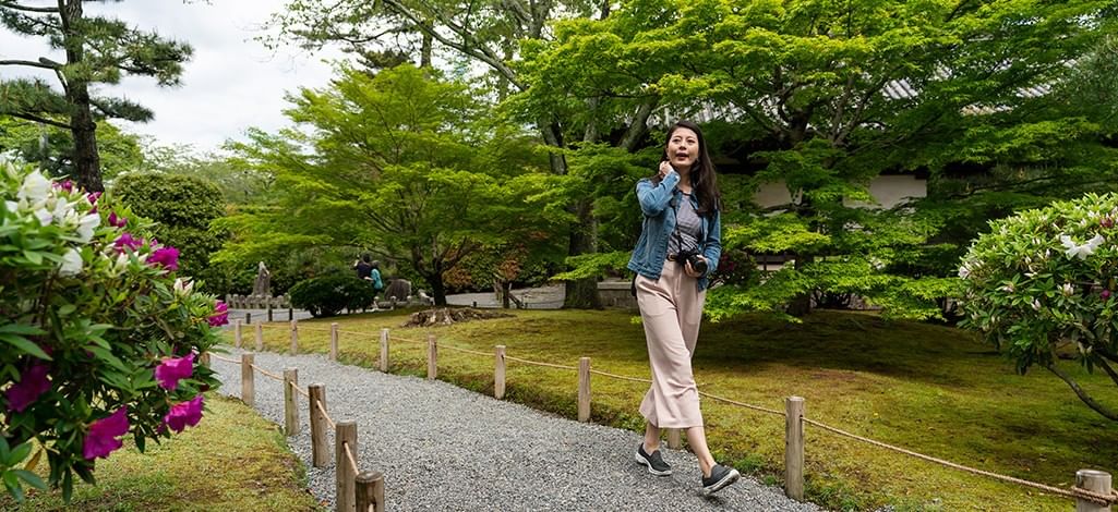 Woman admiring the view in a Japanese-style garden