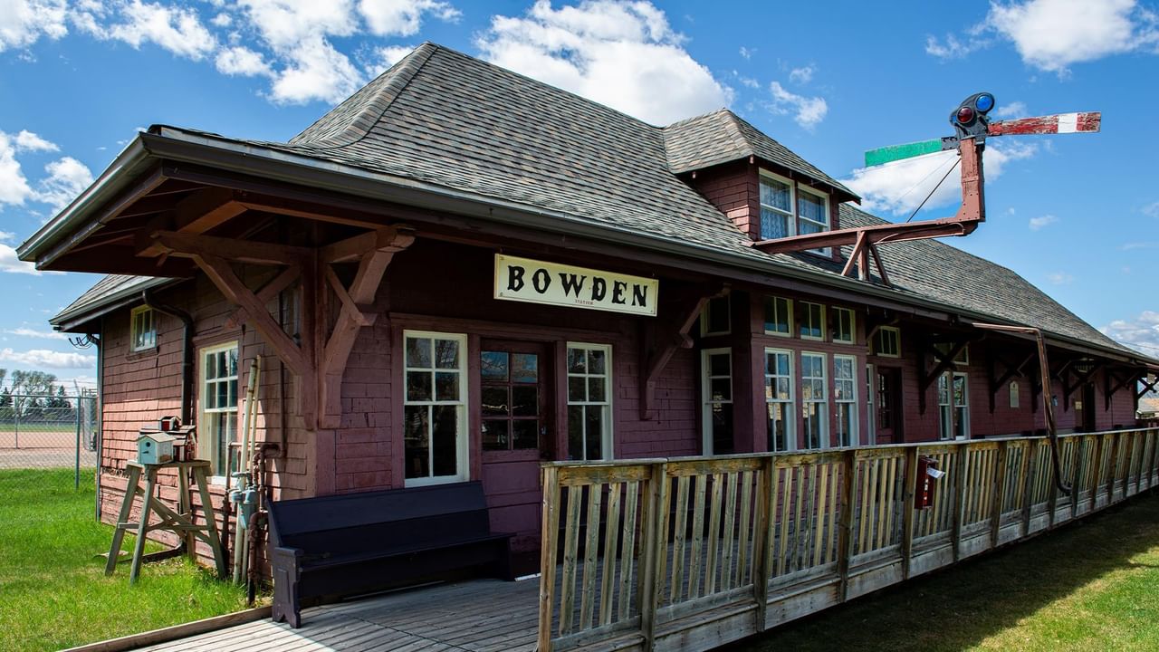 Red wooden old-style train station in a historical village.