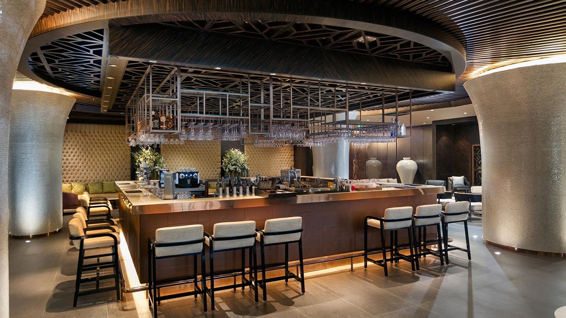 В Lounge Bar отеля Titanic Mardan Palace элегантная барная стойка с высокими табуретами создаёт стильную и уютную атмосферу, идеально подходящую для расслабленного общения и наслаждения напитками.