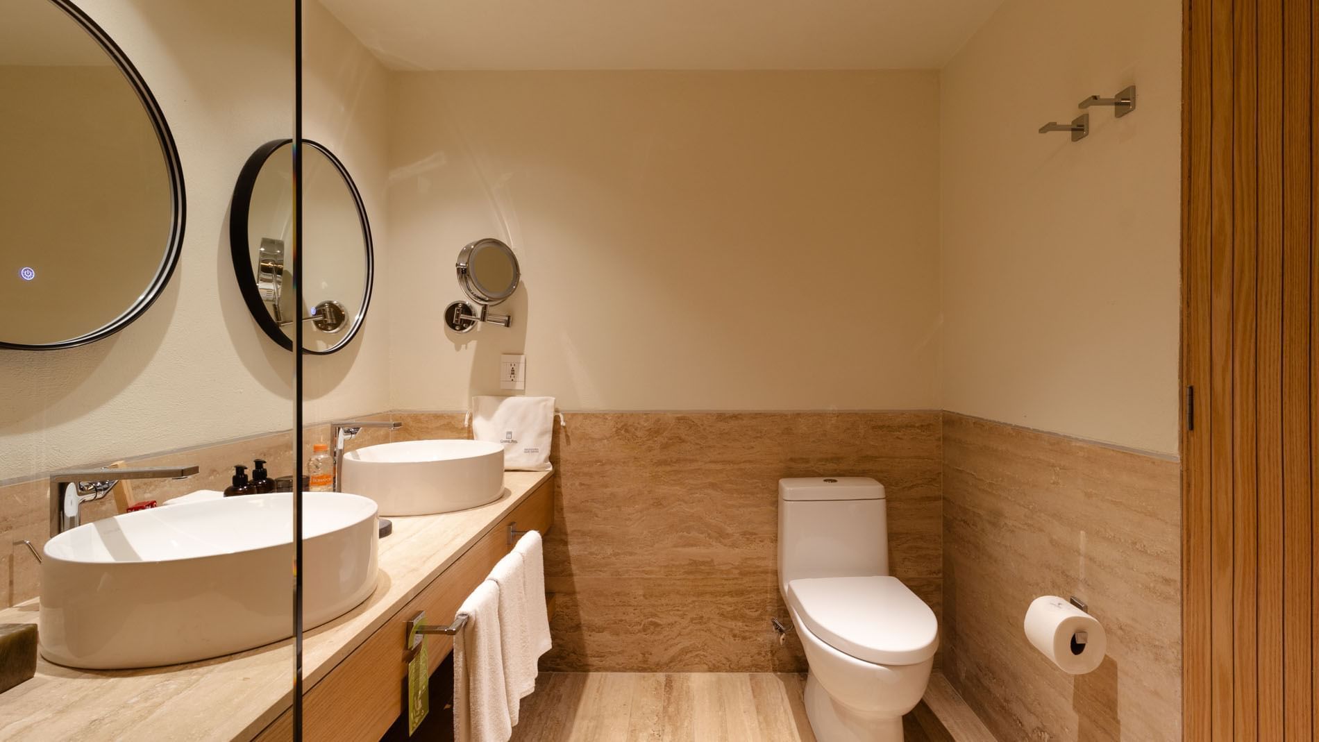 2 Double Superior Camino Real Club Garden View bathroom with dual sinks and stone wall tiling at Camino Real Polanco Mexico