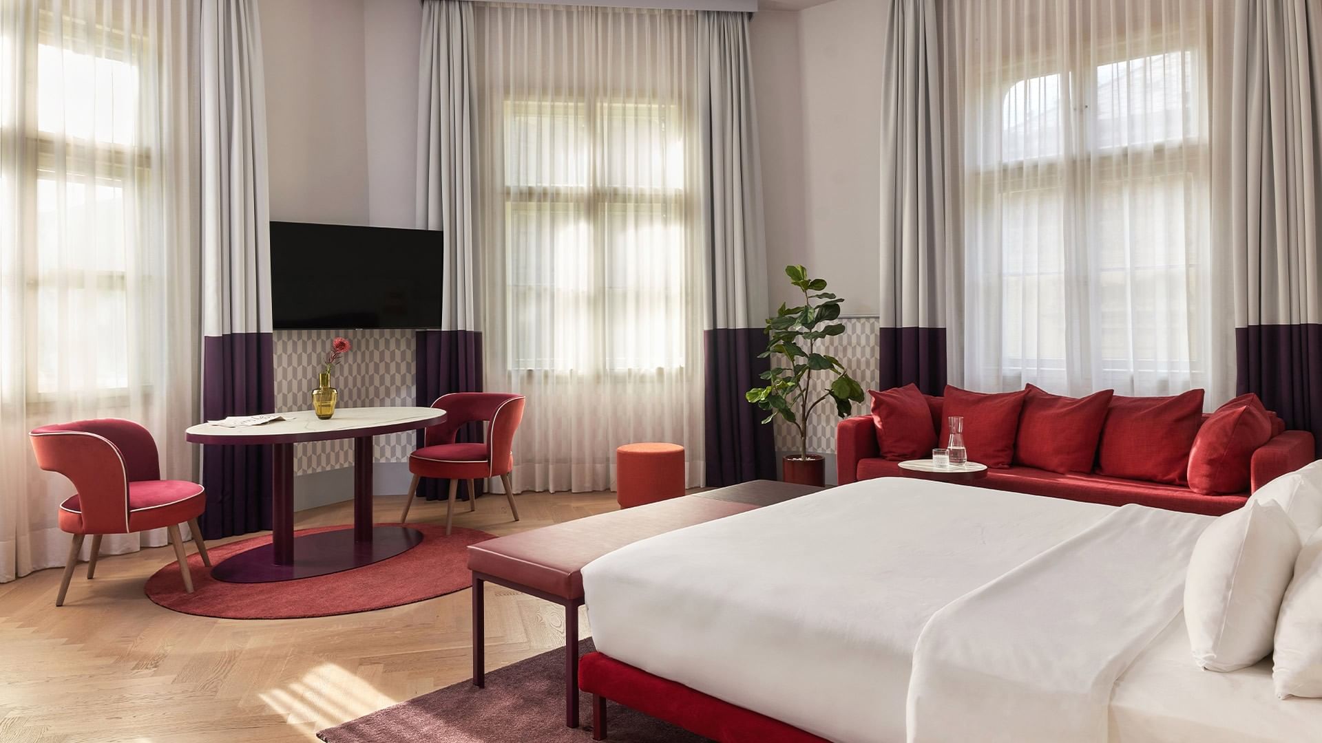 Junior Suite s postelí, čalouněným nábytkem a TV na Falkensteiner Hotel Prague v Praze.