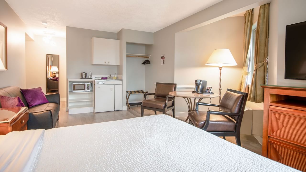 A hotel studio suite with queen bed and kitchenette