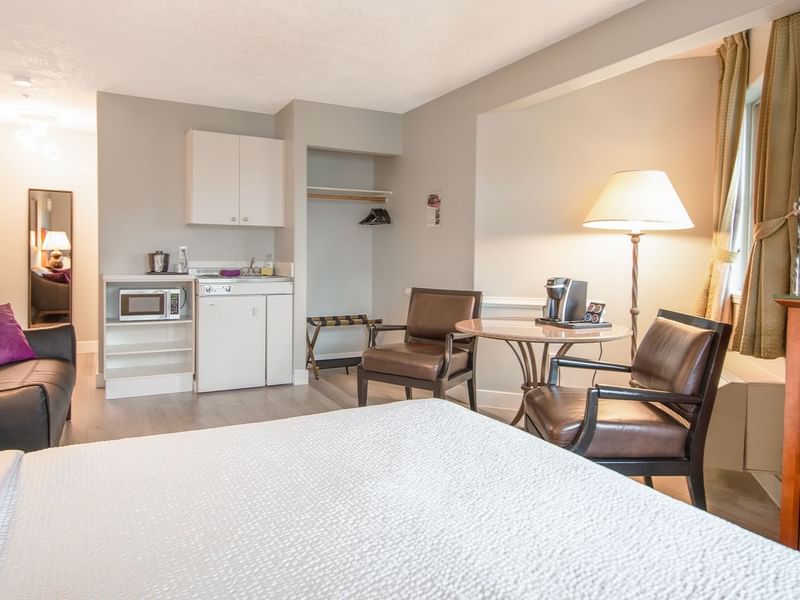 A hotel studio suite with queen bed and kitchenette