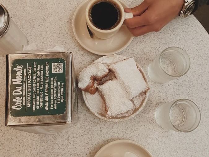 a table with coffee, pastries, and water