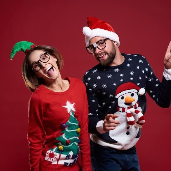 People wearing Christmas jumpers featuring our article on 