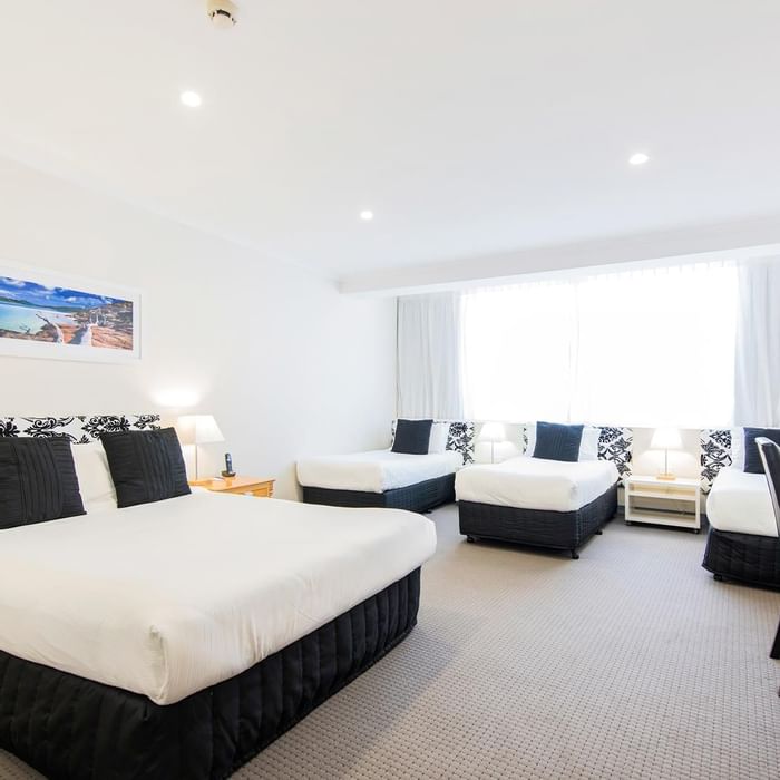 Interior of the Family Room with 3 single and 1 king bed at Mercure Charlestown