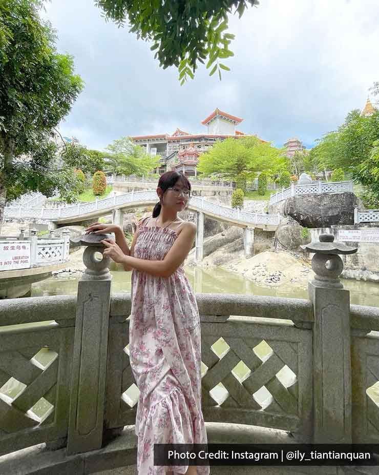 A Chinese lady was taking a picture inside the Kek Lok Si temple - Lexis Suites Penang
