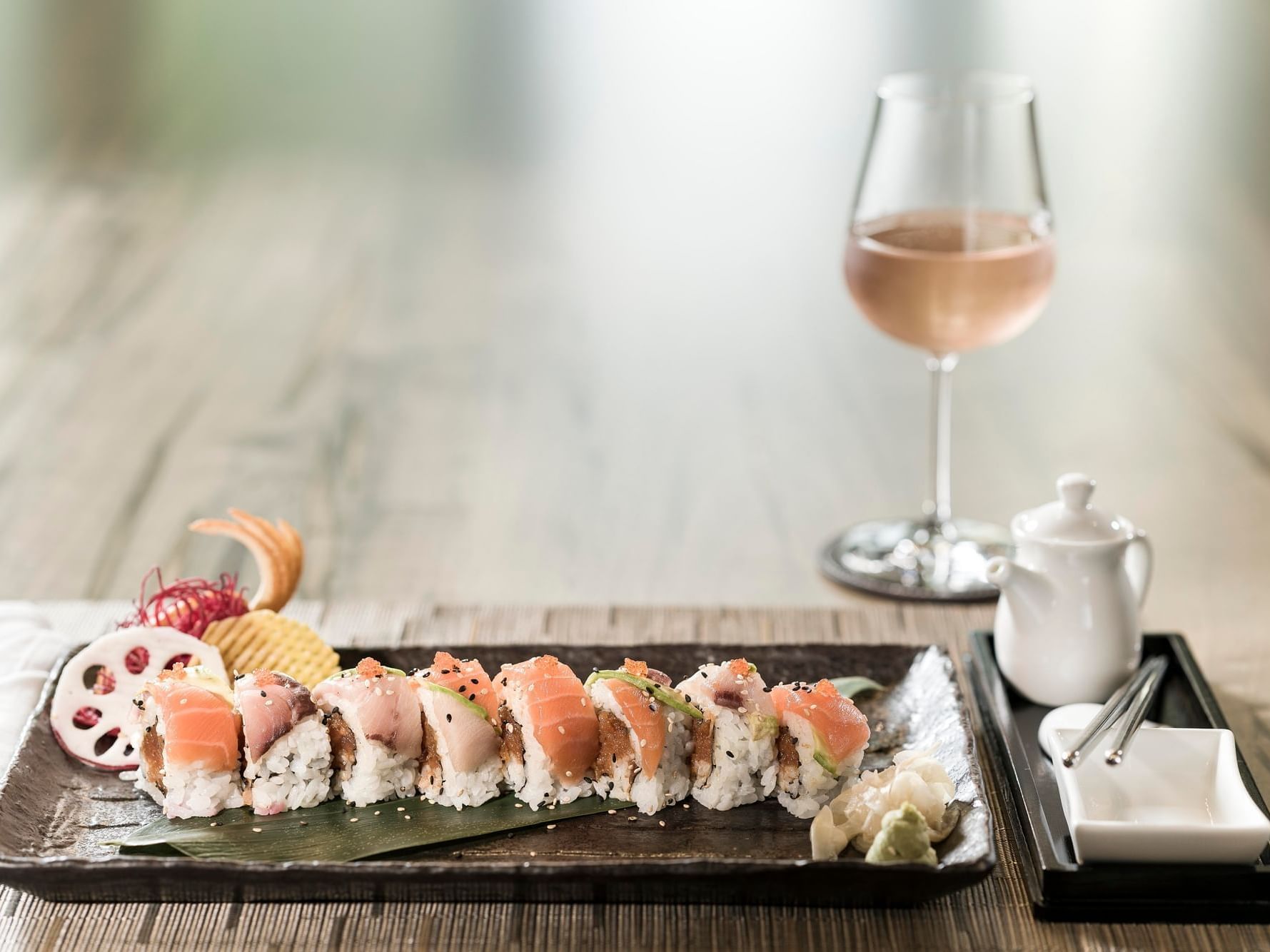 Sushi dish served with wine in restaurant at Innovation Hotel