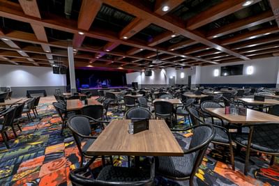 Dining area with carpeted floors in Joker's Cafe at Service Plus Inns & Suites