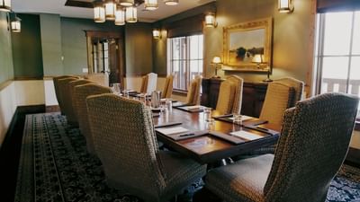 Large wooden table with chairs by the window and carpet floors in Board Room at Hotel Park City Autograph Collection 