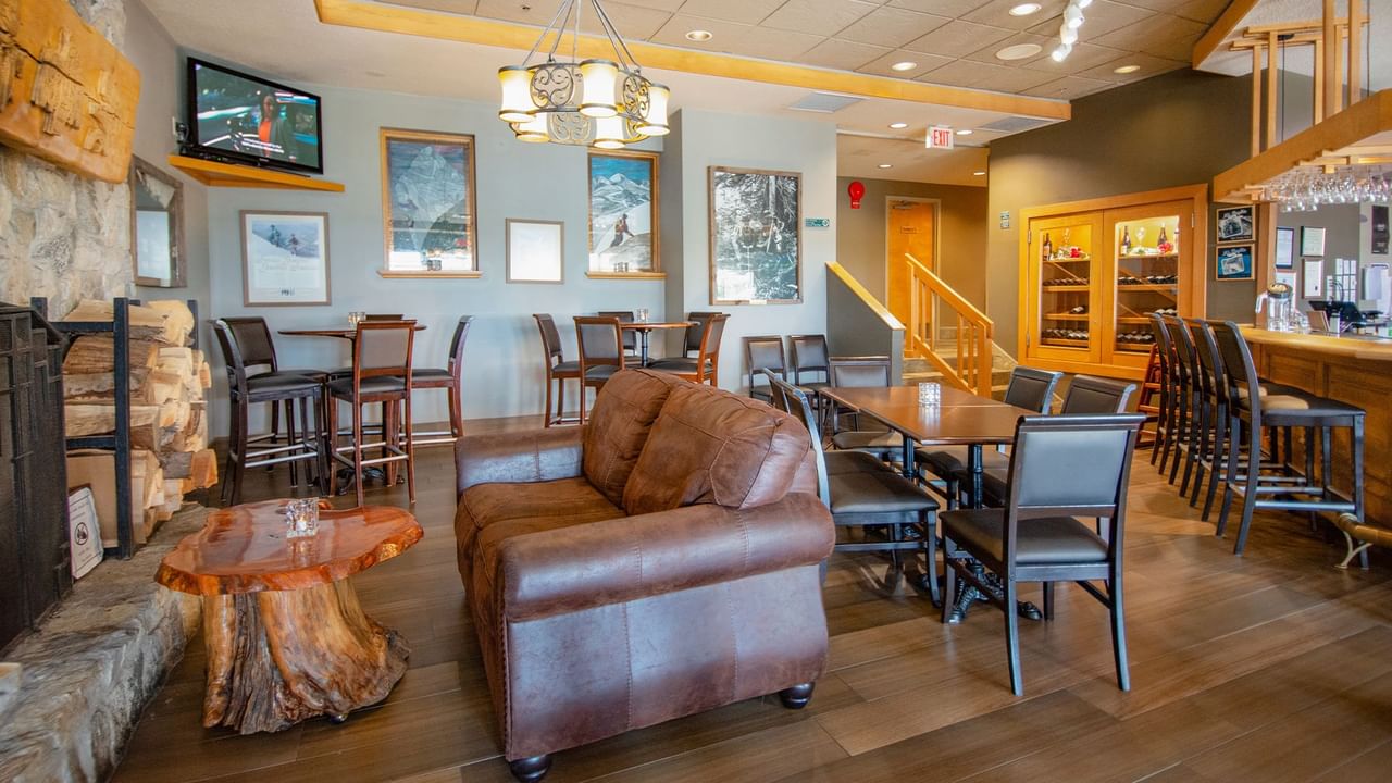 Hotel restaurant with dining table, chair, and bar
