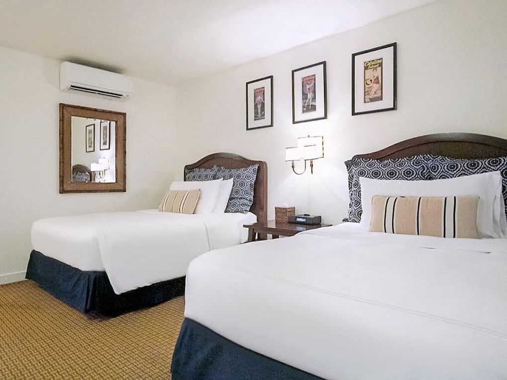 Two beds with nightstand and wall mirror in Premier Double Rooms at Pavilion Hotel