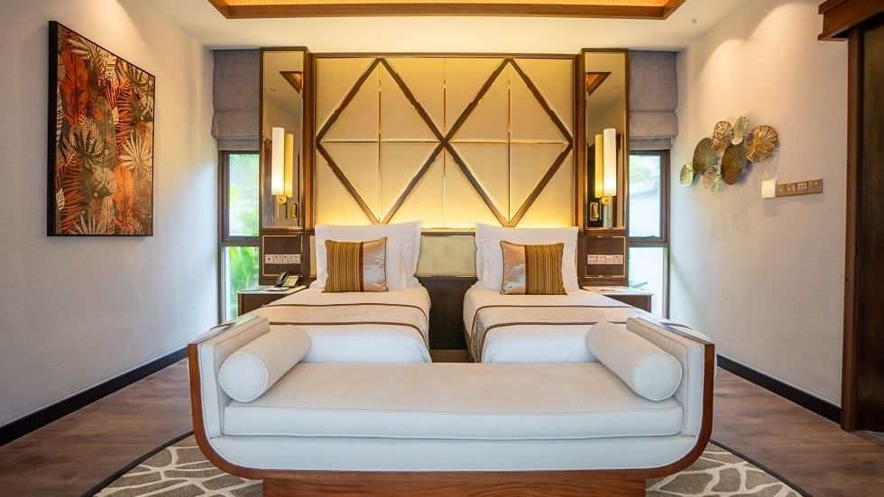 Spacious Royal Villa bedroom with twin beds, geometric headboard, and modern furnishings at The Banjaran Hotsprings Retreat.