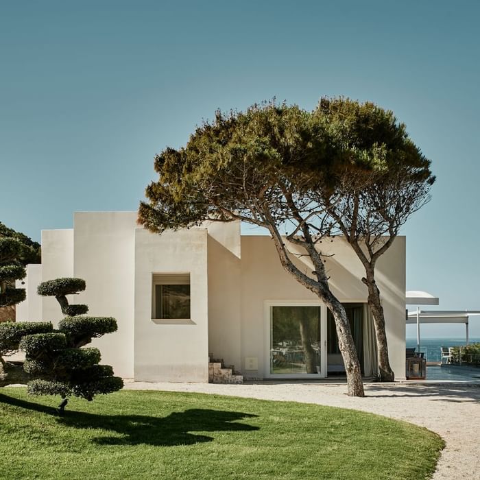 Modern house surrounded by grass against a clear sky and ocean view at Falkensteiner Hotels & Residences