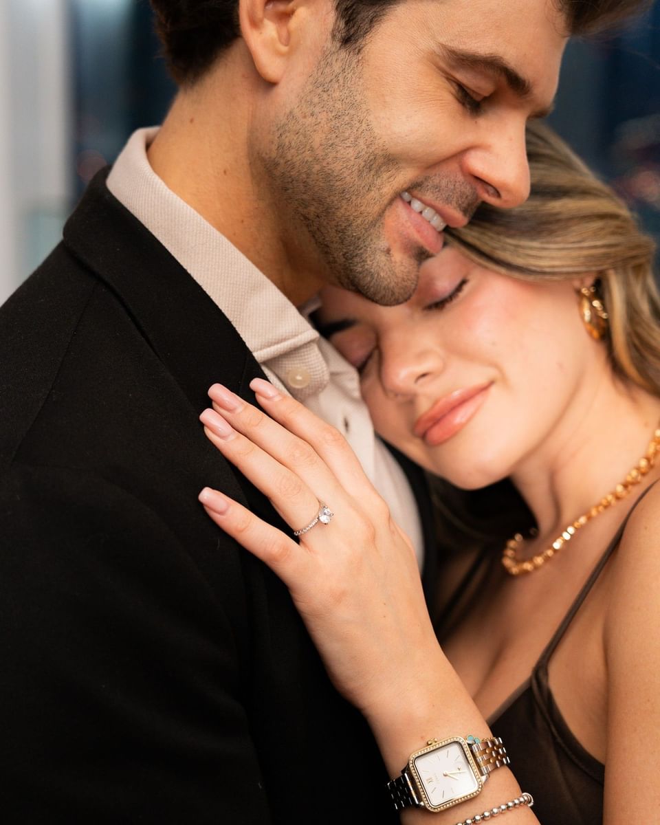 Engaged couple embracing with a diamond ring on display during an intimate romantic celebration at Hotel X Toronto