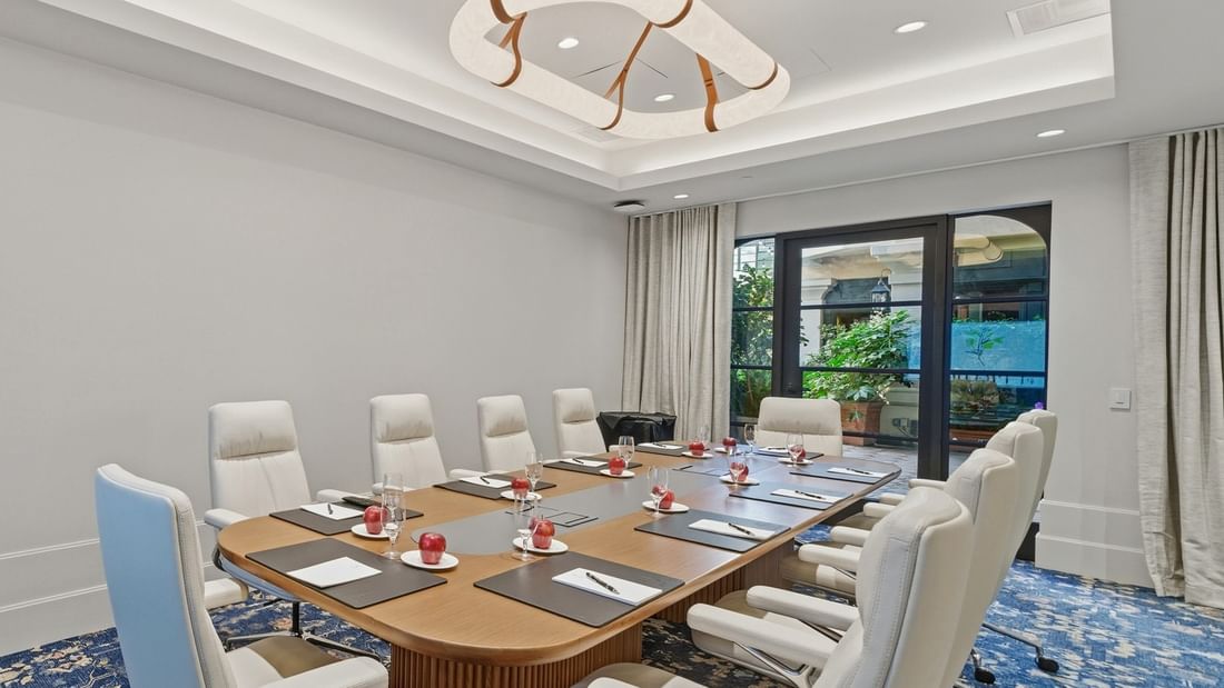 Granada event room with large table and chairs at el PRADO Hotel in Palo Alto.