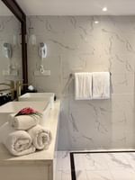 Clean bathroom with towels, sinks, and a wooden door at Warwick Fiji Resort and Spa, Korolevu.