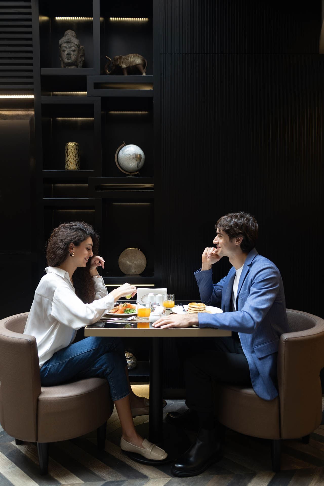 Couple enjoying a Breakfast meal in the Dining Room while gazing at each other in The Style