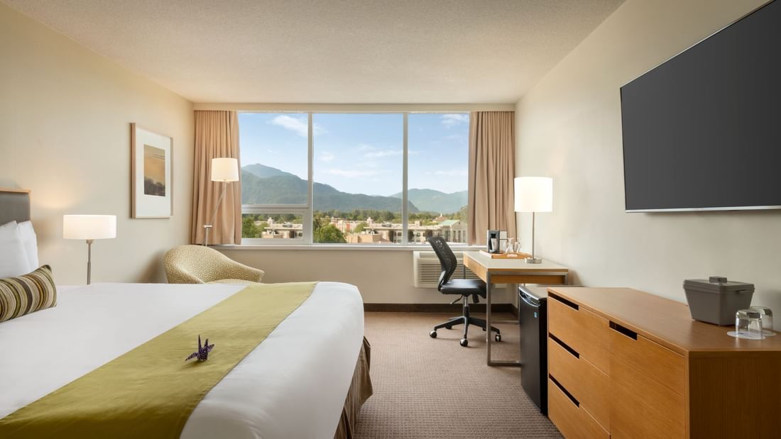 Bed in hotel room with mountain views