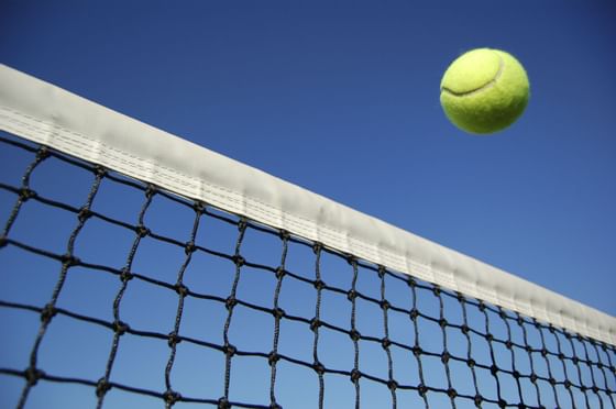 Closeup of a tennis ball flying over a net at Mont Gabriel