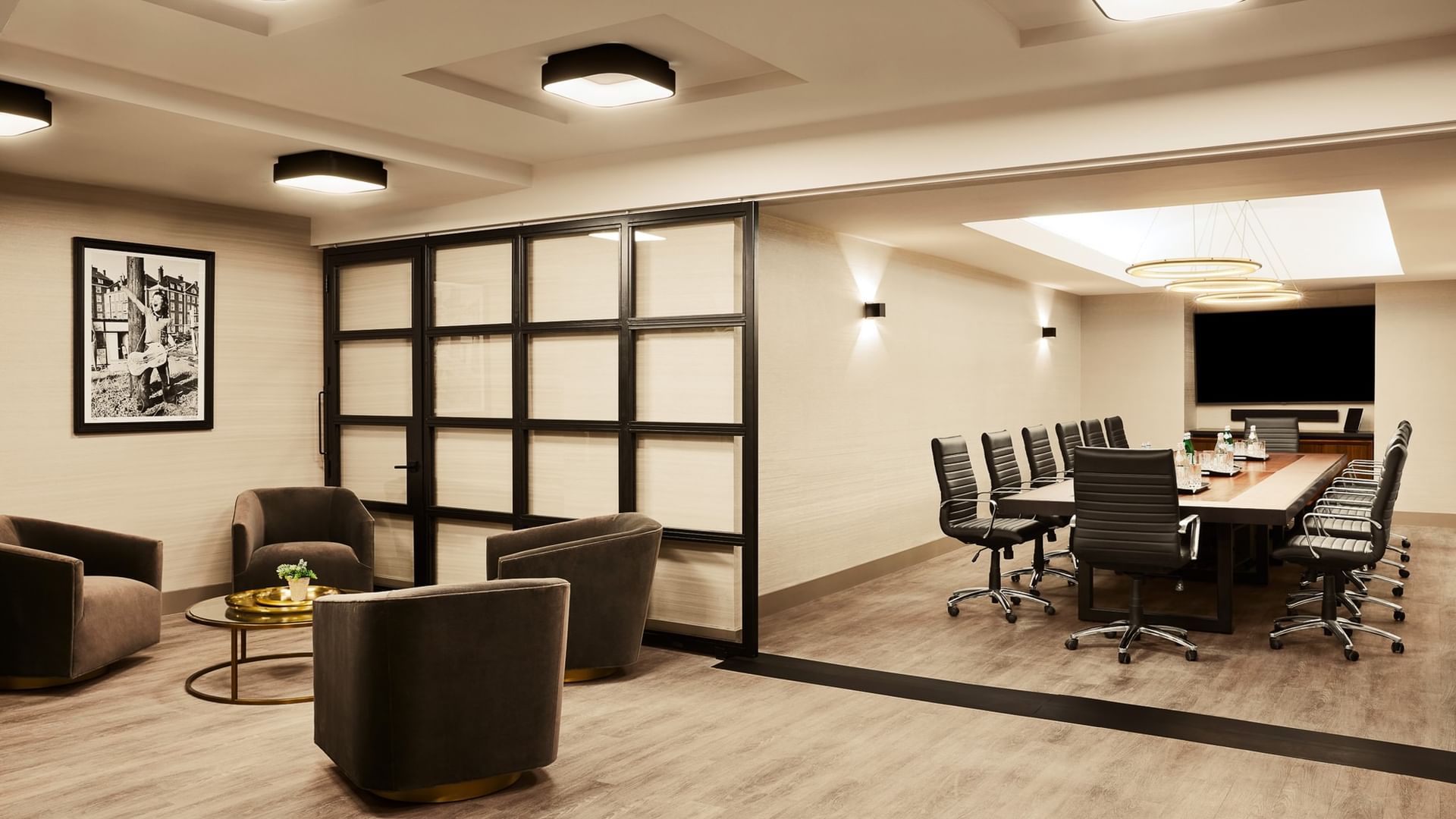 Modern Executive Boardroom with conference table, lounge seating, and glass partition at Gansevoort Meatpacking NYC - NEW