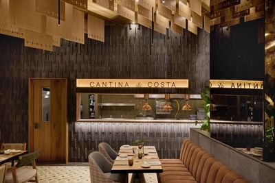 Sophisticated restaurant interior design with warm lighting and comfortable dining booth setups.
