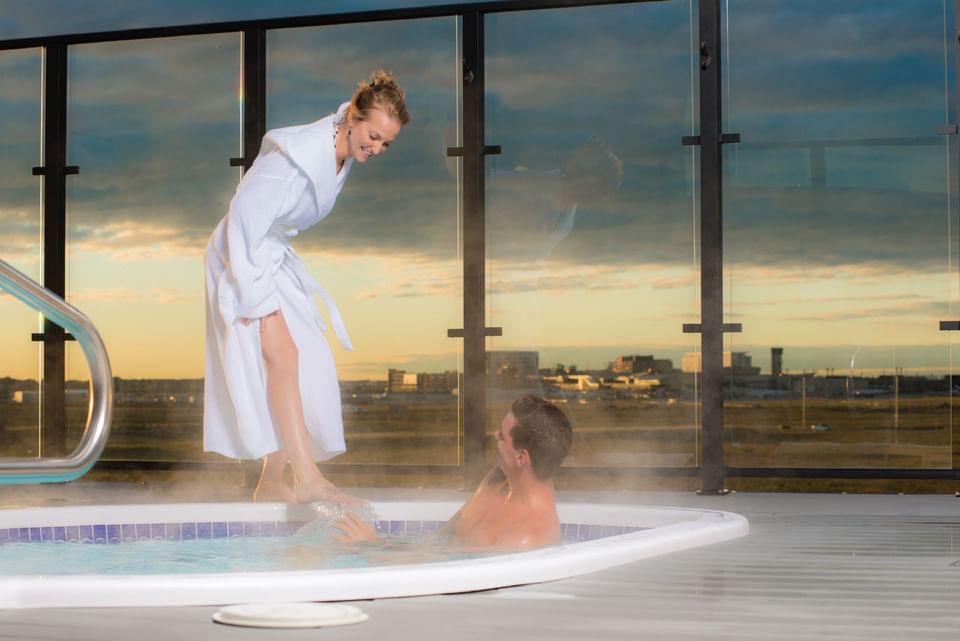 Couple enjoying in a hot bathtub, Hotel Clique Calgary Airport