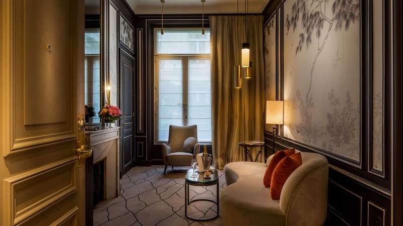 Deluxe Parisian suite living room with comfy sofa and warm lighting at Hôtel Westminster - Paris