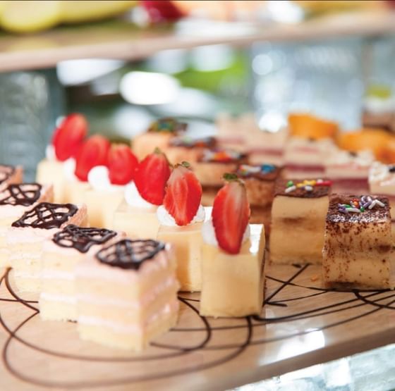 Mini cakes served on a wooden board at Federal Hotels International