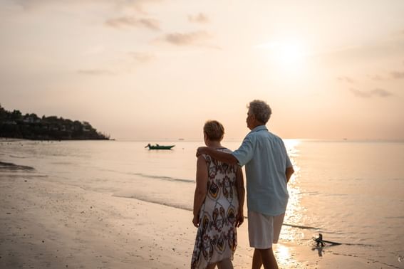 Mature couple walking by the sea near Tanjung Rhu Resort