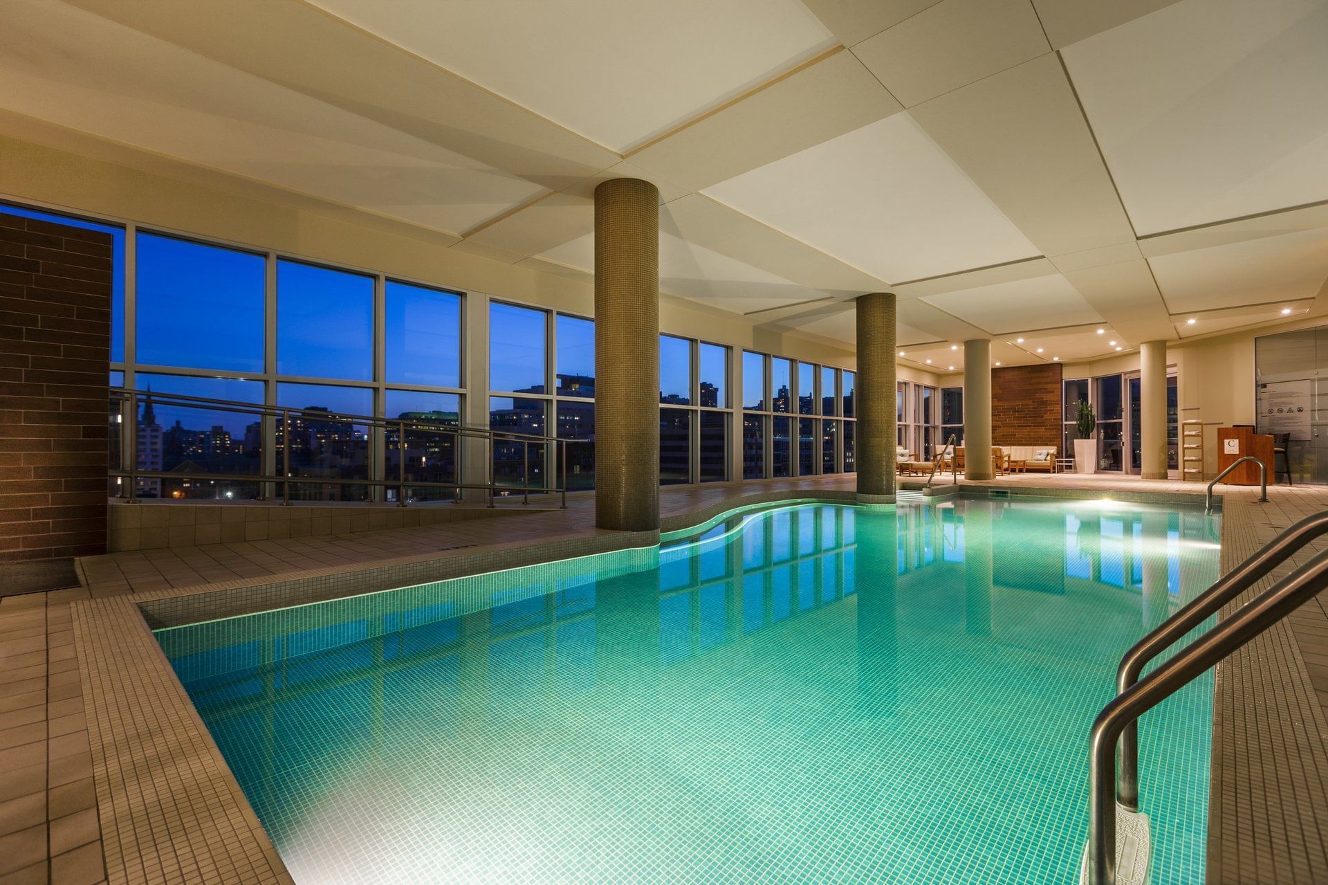 Indoor pool with city view at Warwick Le Crystal - Montreal
