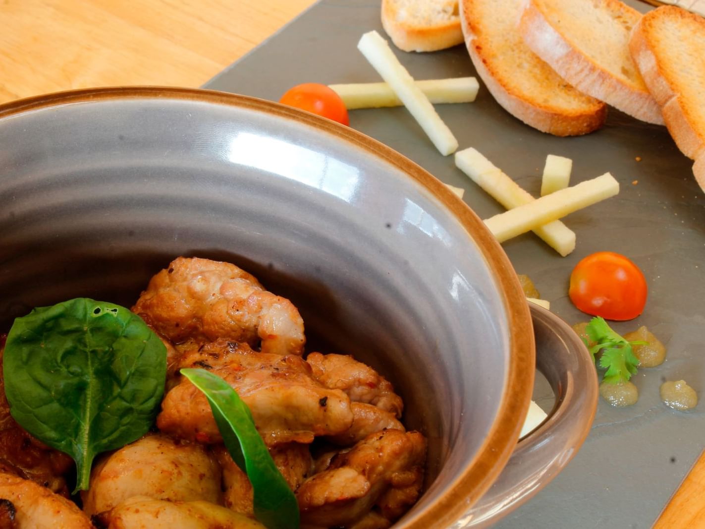 Close up on chicken & garlic bread meal at NOI Indigo Patagonia