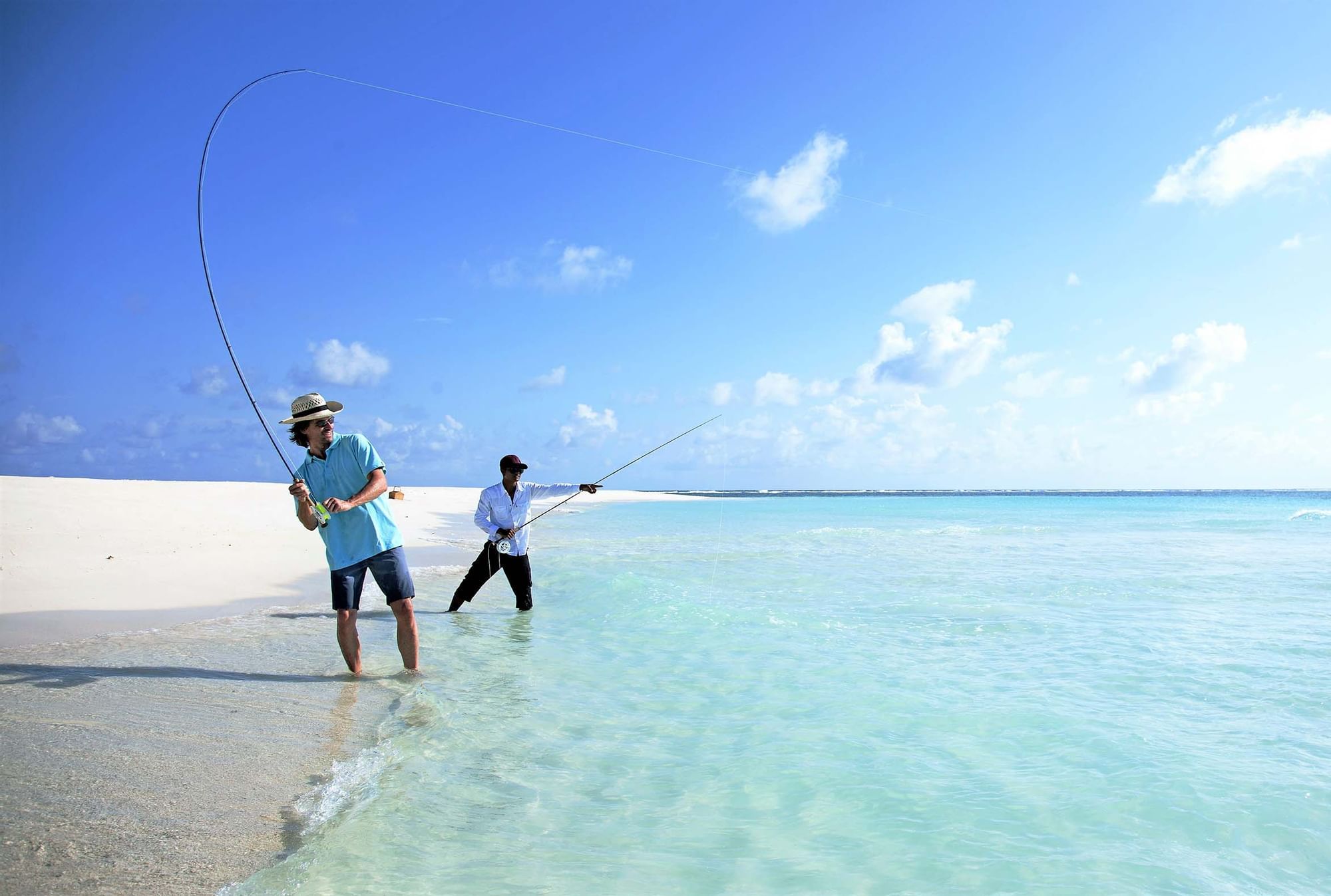 2 men fishing in the sea near The Signature Collection