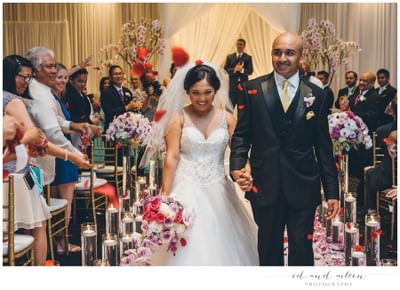 a bride and groom walk down the isle
