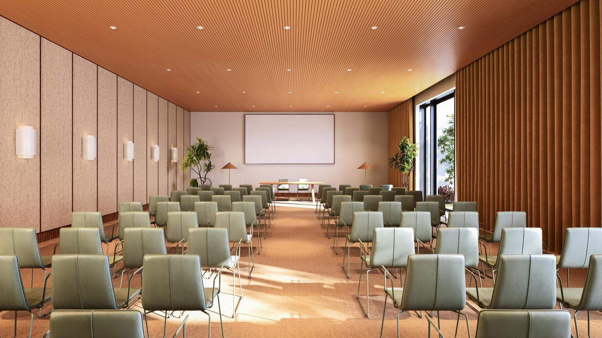Empty conference room with rows of chairs, a podium, and a large blank screen.
