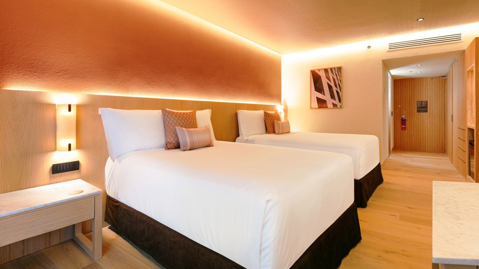 2 Double Deluxe Plus room featuring orange walls and glowing recessed lighting at Camino Real Polanco Mexico
