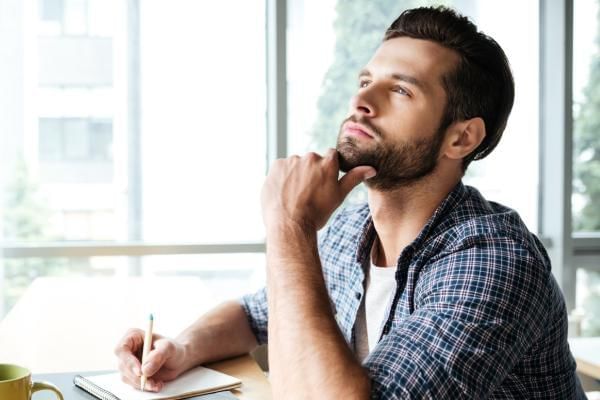 Man thinking whilst working