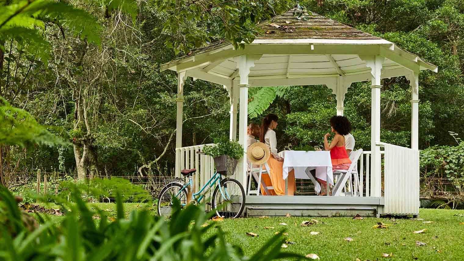 Ladies dining in a gazebo in Firescreek Botanical Winery near Pullman Magenta Shores