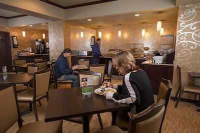 People enjoying meals in the Breakfast Room at Service Plus Inns & Suites