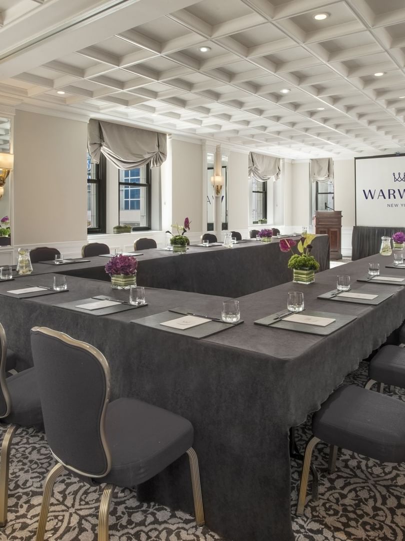 U-shaped table setup facing the screen near the window with a white coffered ceiling in Kent at Warwick New York