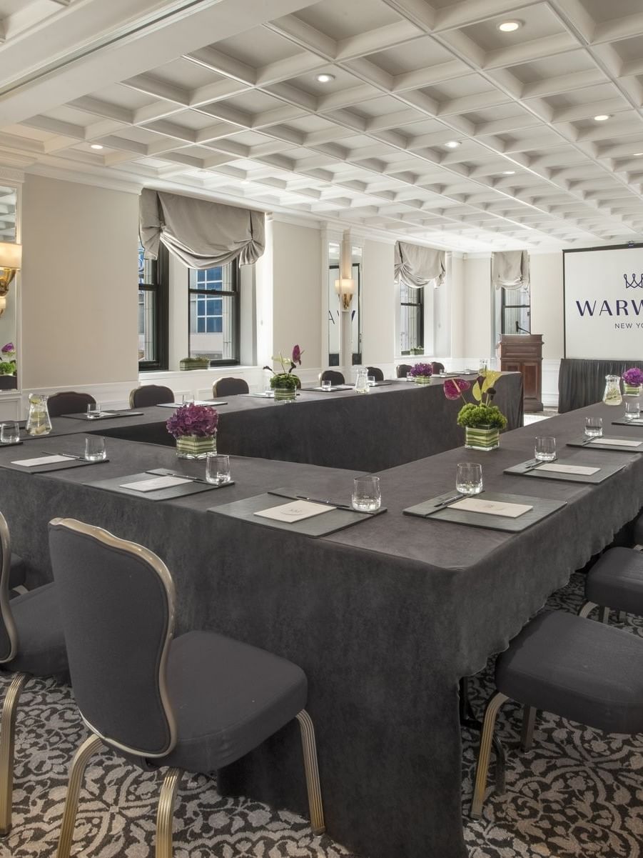 U-shaped table setup facing the screen near window with white coffered ceiling in Kent at Warwick New York