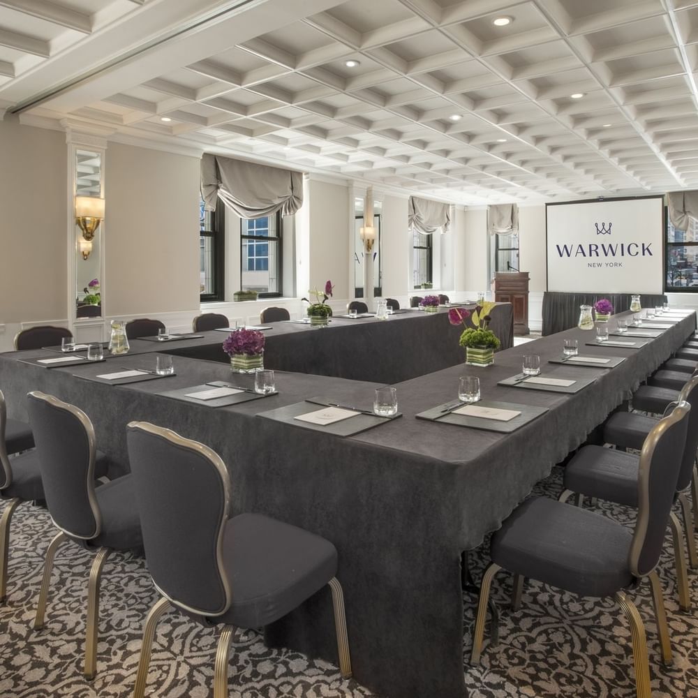 U-shaped table setup facing the screen near window with white coffered ceiling in Kent at Warwick New York